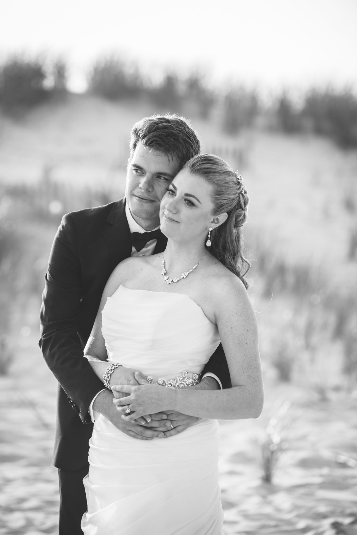 Black and white photo of bride and groom at the dunes of Oceanbleu