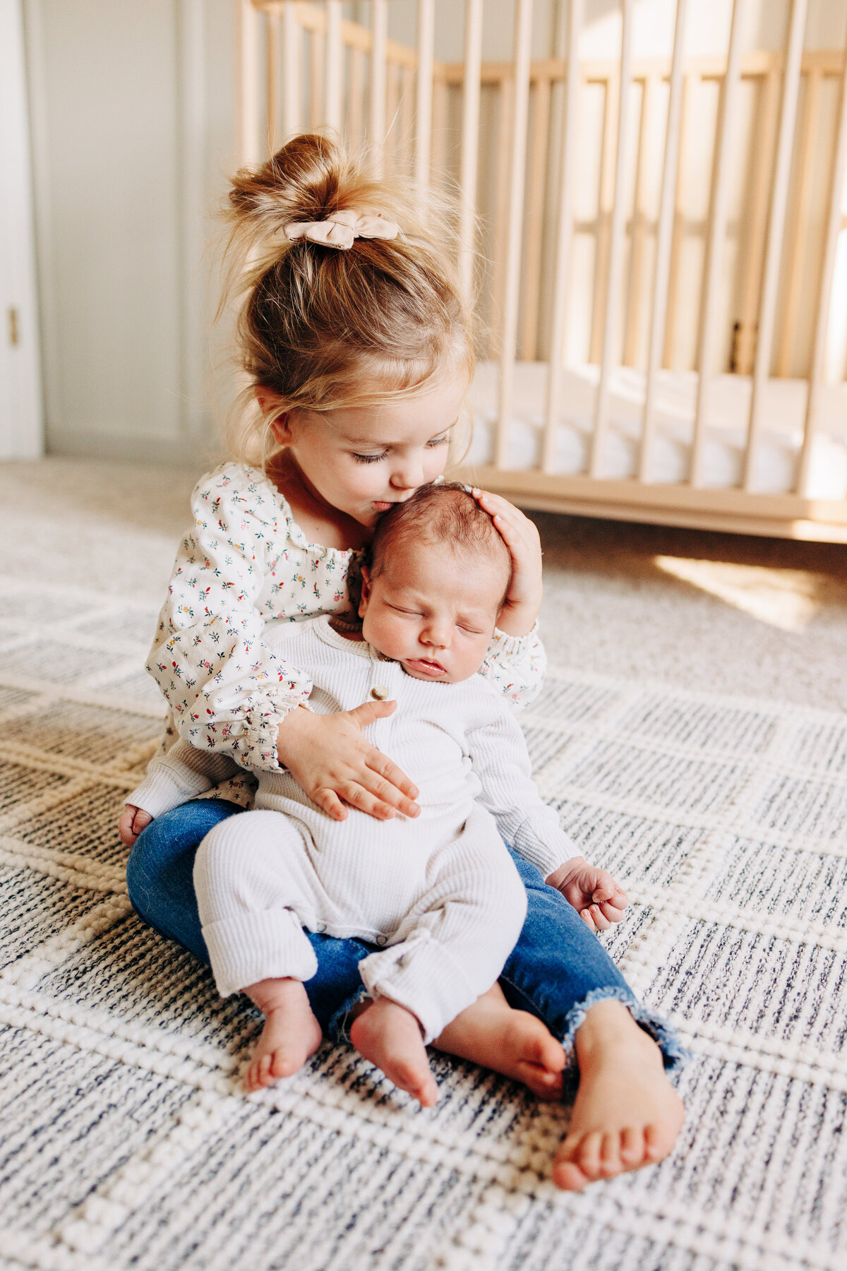 big sister kissing her baby brother