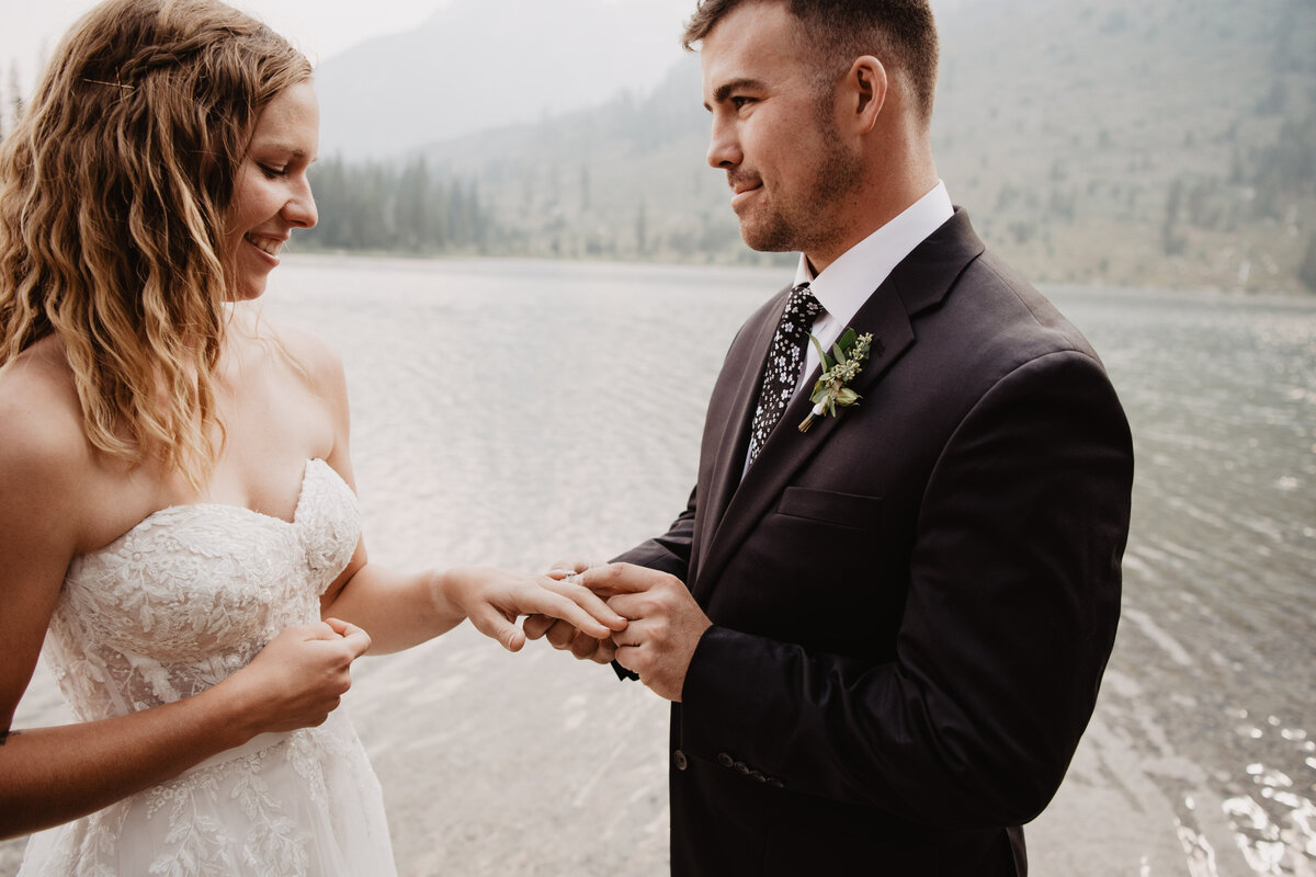 Jackson Hole Photographers capture groom putting ring on bride's finger