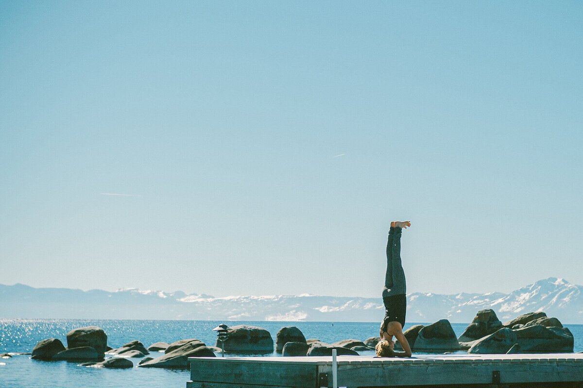 Yoga headshot session at Lake Tahoe doing handstand on a pier