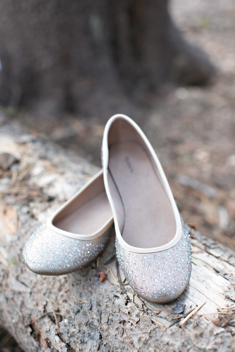 Sparkly wedding shoes for bride on pine tree
