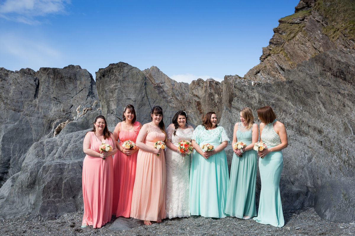 bridesmaids on beach at tunnels beaches colourful dresses