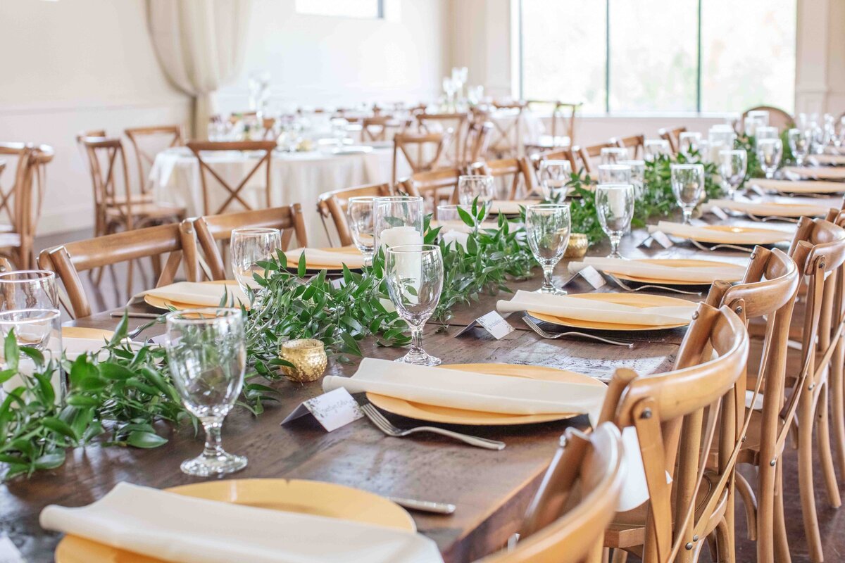 wedding estate table decorated with gold chargers at wedding reception  by Firefly Photography