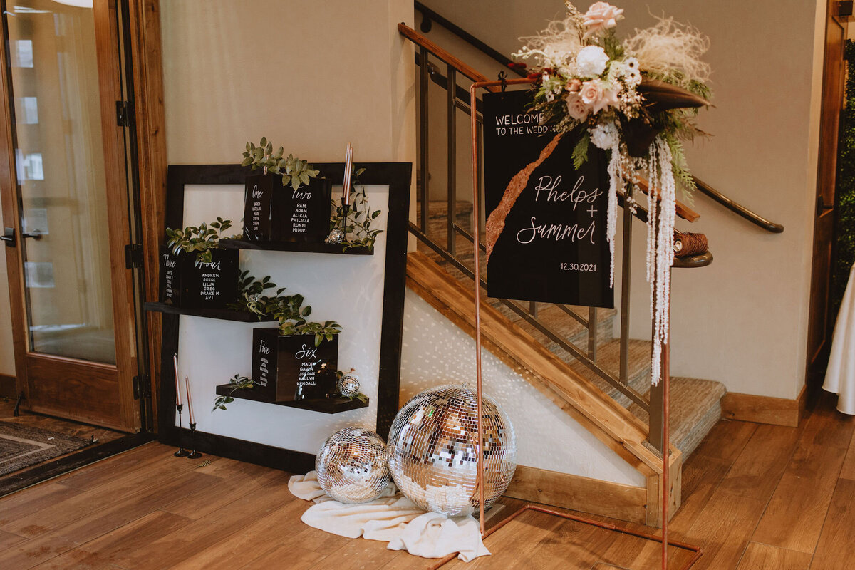 Black and white wedding reception with disco balls and metallic pops
