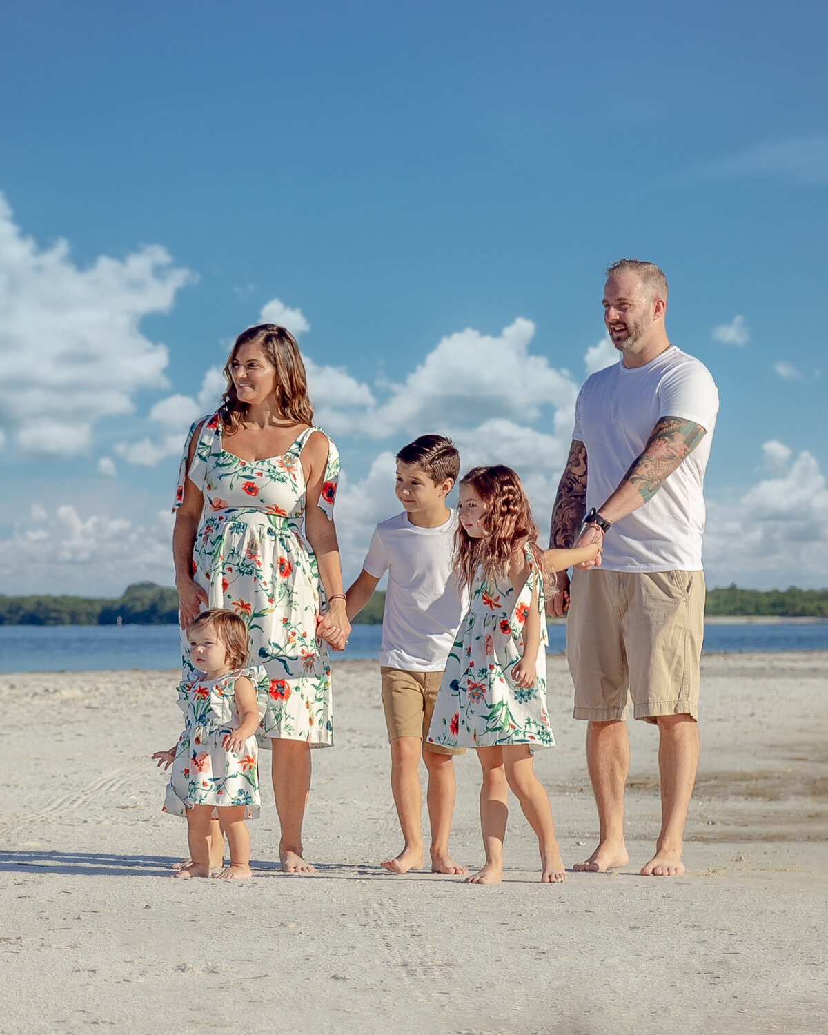 family of five standing at the beach