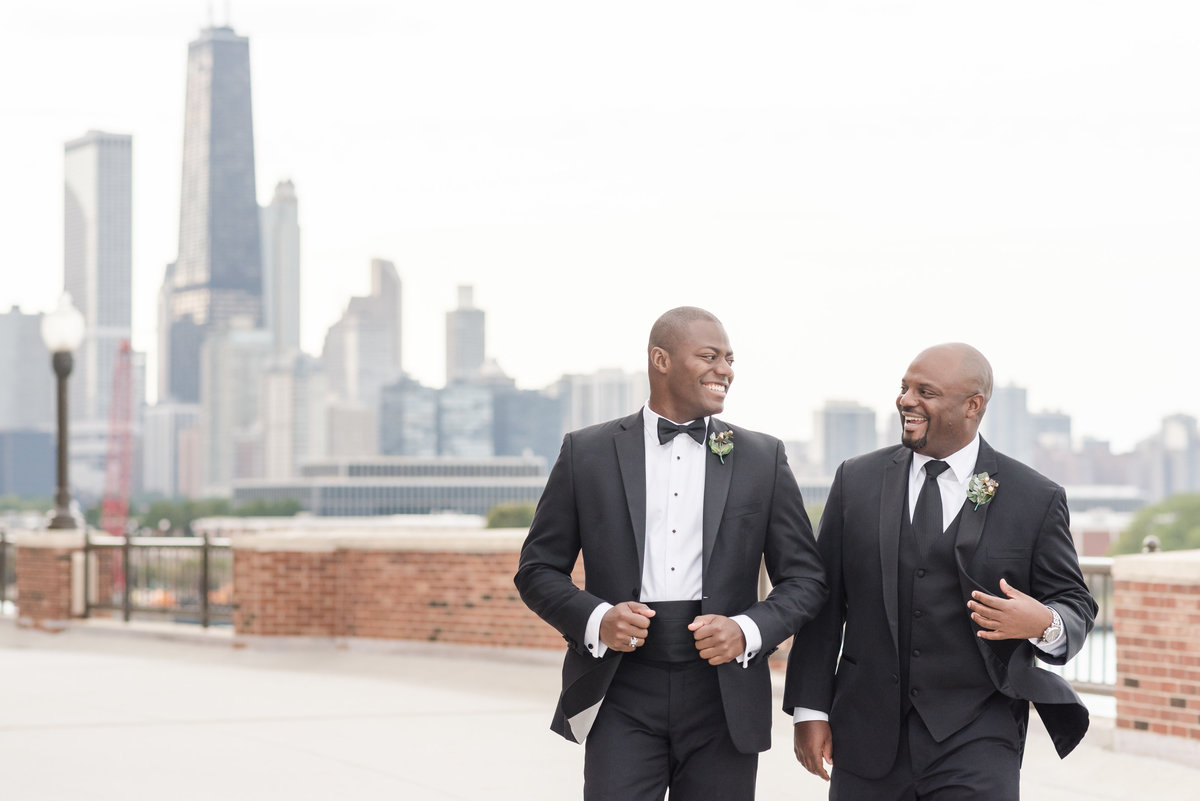 Groom and groomsmen Chicago navy pier skyline wedding