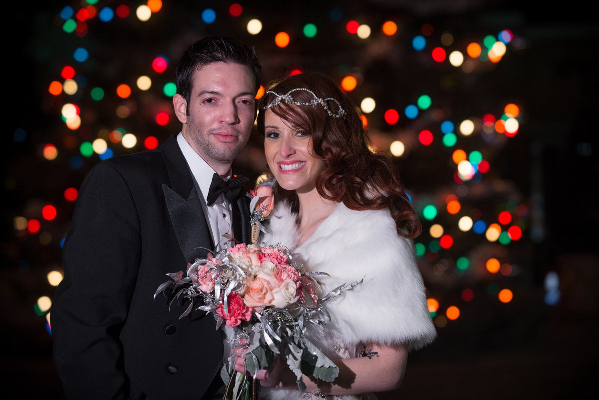 Colored Christmas lights bride and groom portrait