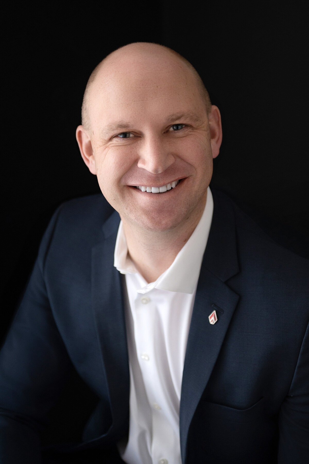 A Pewaukee businessman has his professional headshot taken wearing a navy suit in our Waukesha portrait studio.