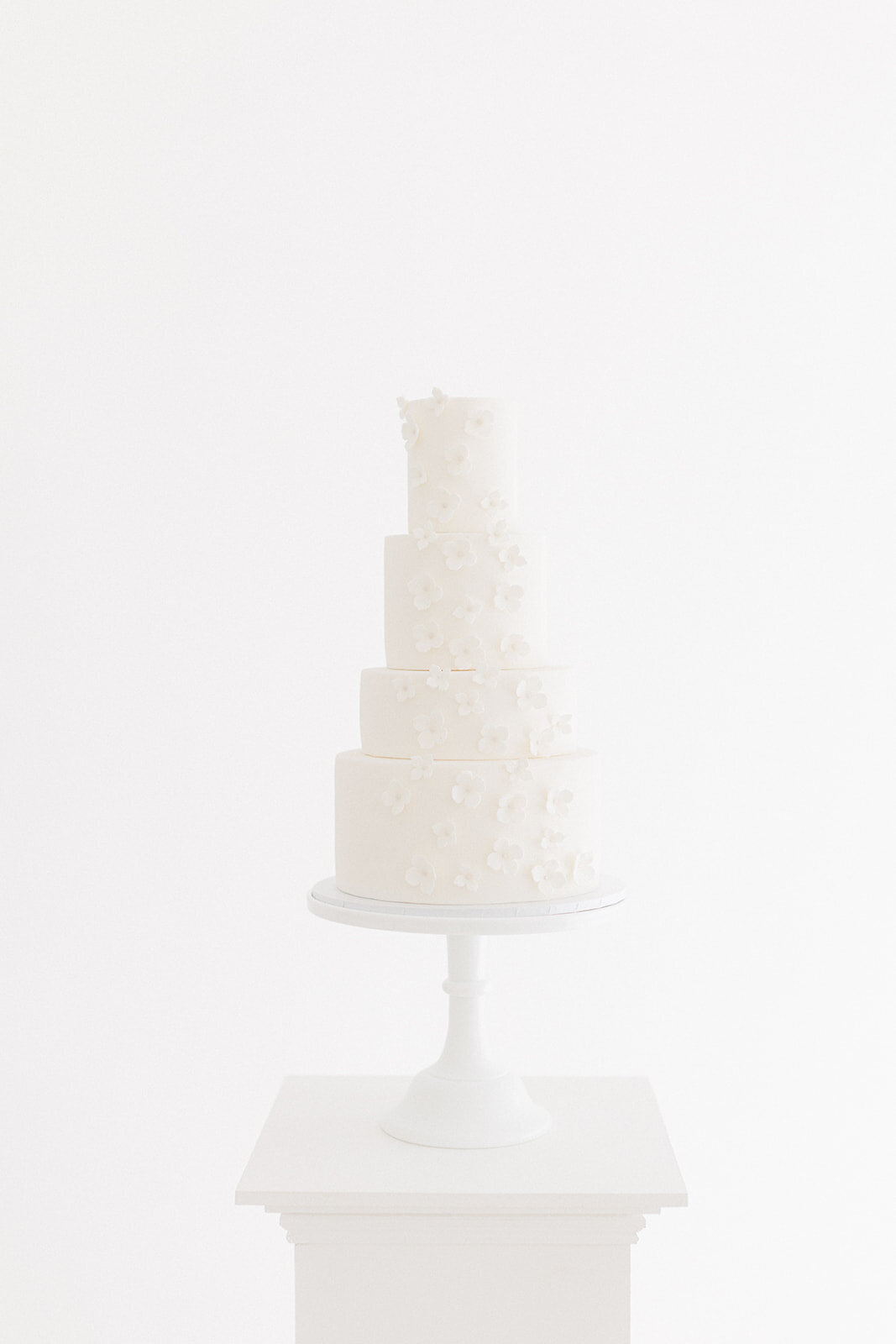 All white wedding cake with sugar flower blossoms