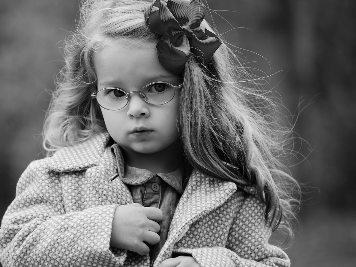 charlotte family photographer jamie lucido creates beautiful black and white portrait of a young girl in fall with her coat on