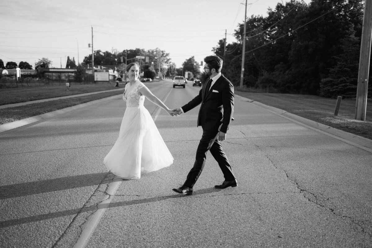 bride and groom cross the street