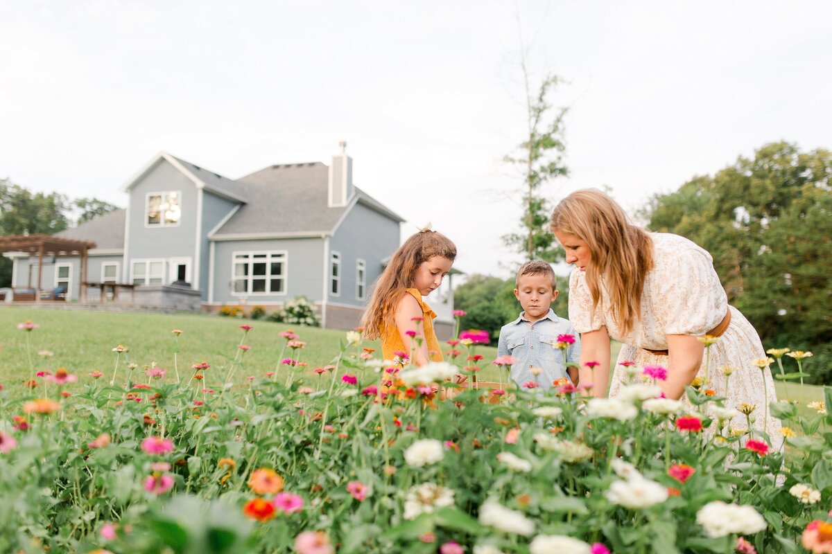 A mom with her son and daughter in a zinnia garden in Berea KY.