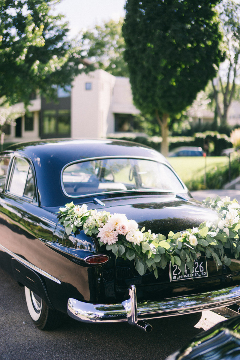wedding flowers on a vintage car