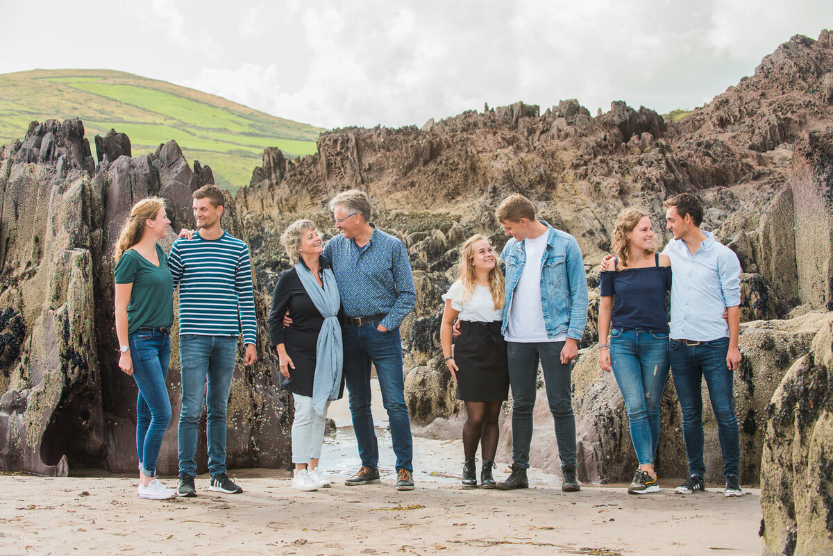 portrait of a grown up family with partners on a beach in Ireland, wearing blue denim