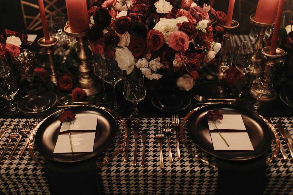 This wedding is a mood, houndstooth linen, black leather runners, and burgundy and cream flowers!