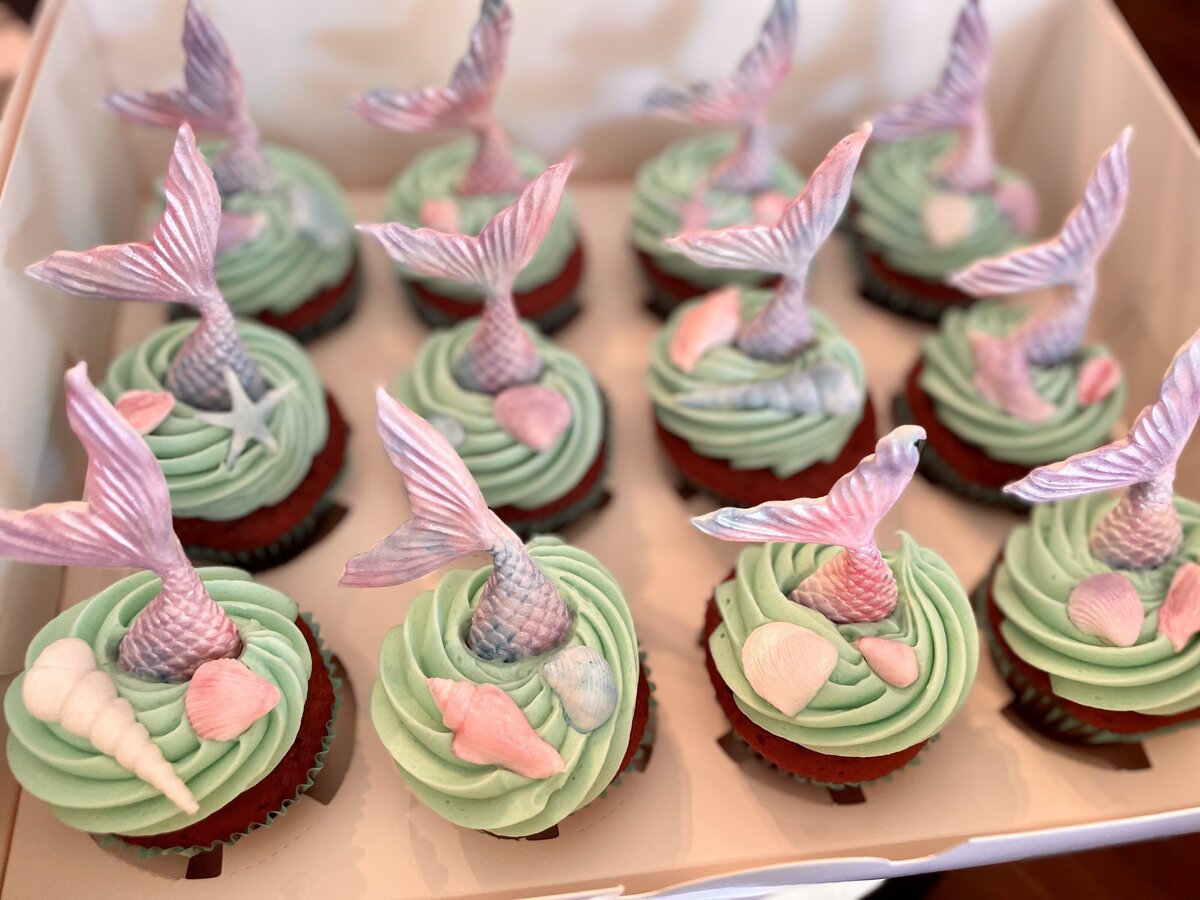 Custom-designed mermaid cupcakes with intricate icing details, perfect for birthdays, made in Gilbert.