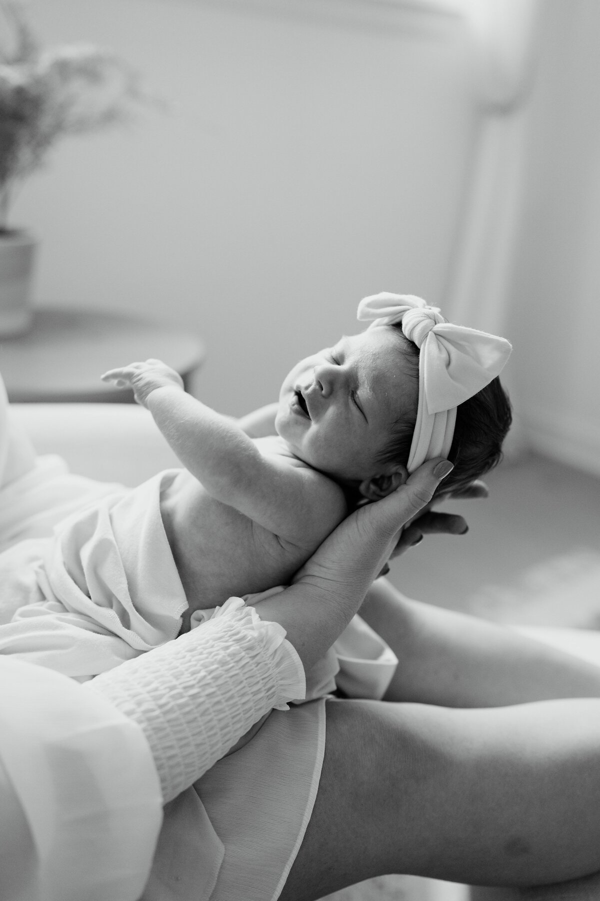 Newborn cradled in mothers lap