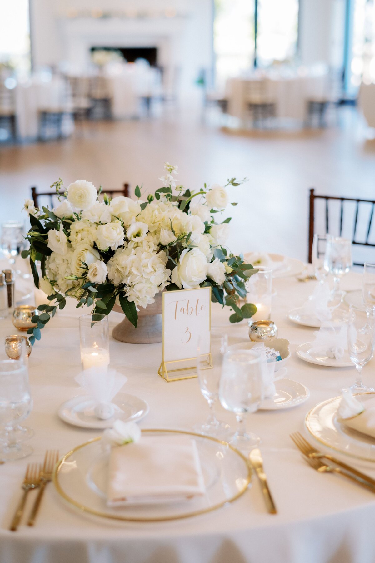A white bouquet on a wedding table for guests.
