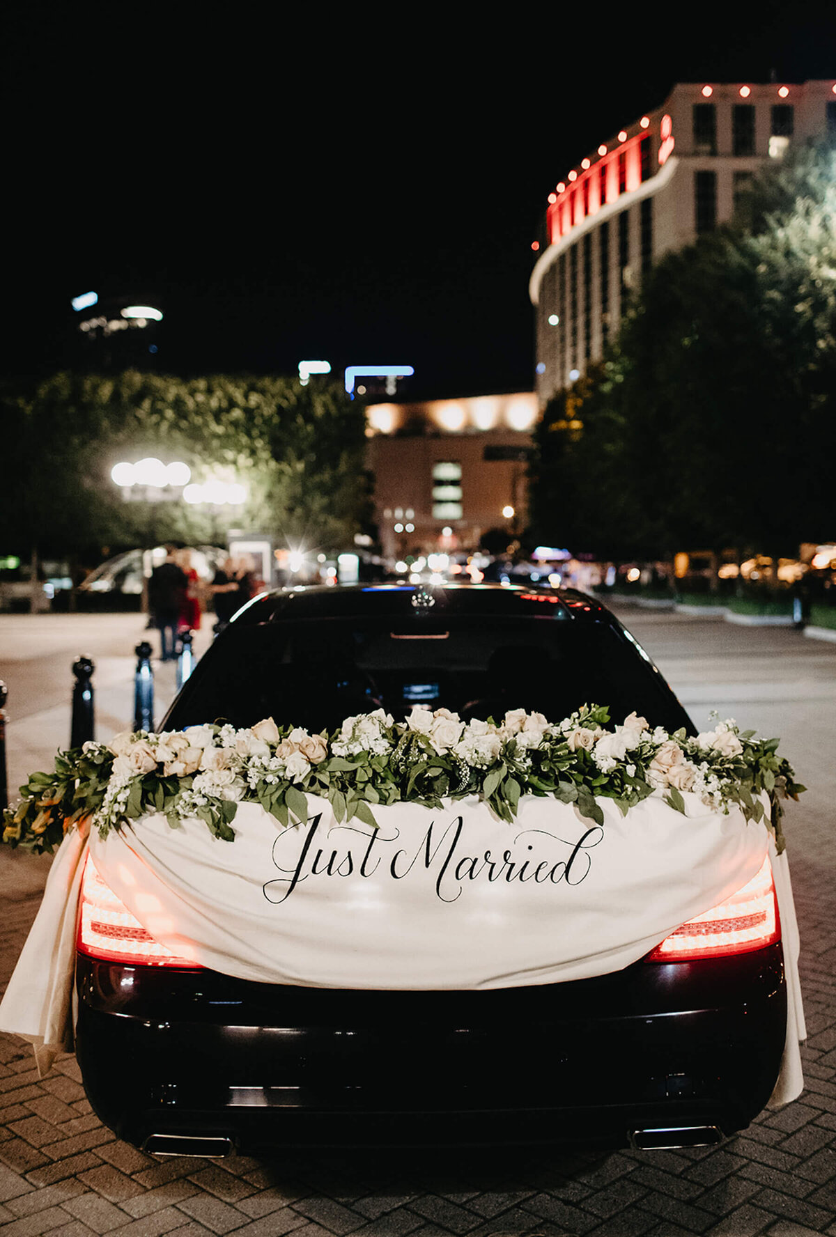 Just Married sign with flowers on wedding car