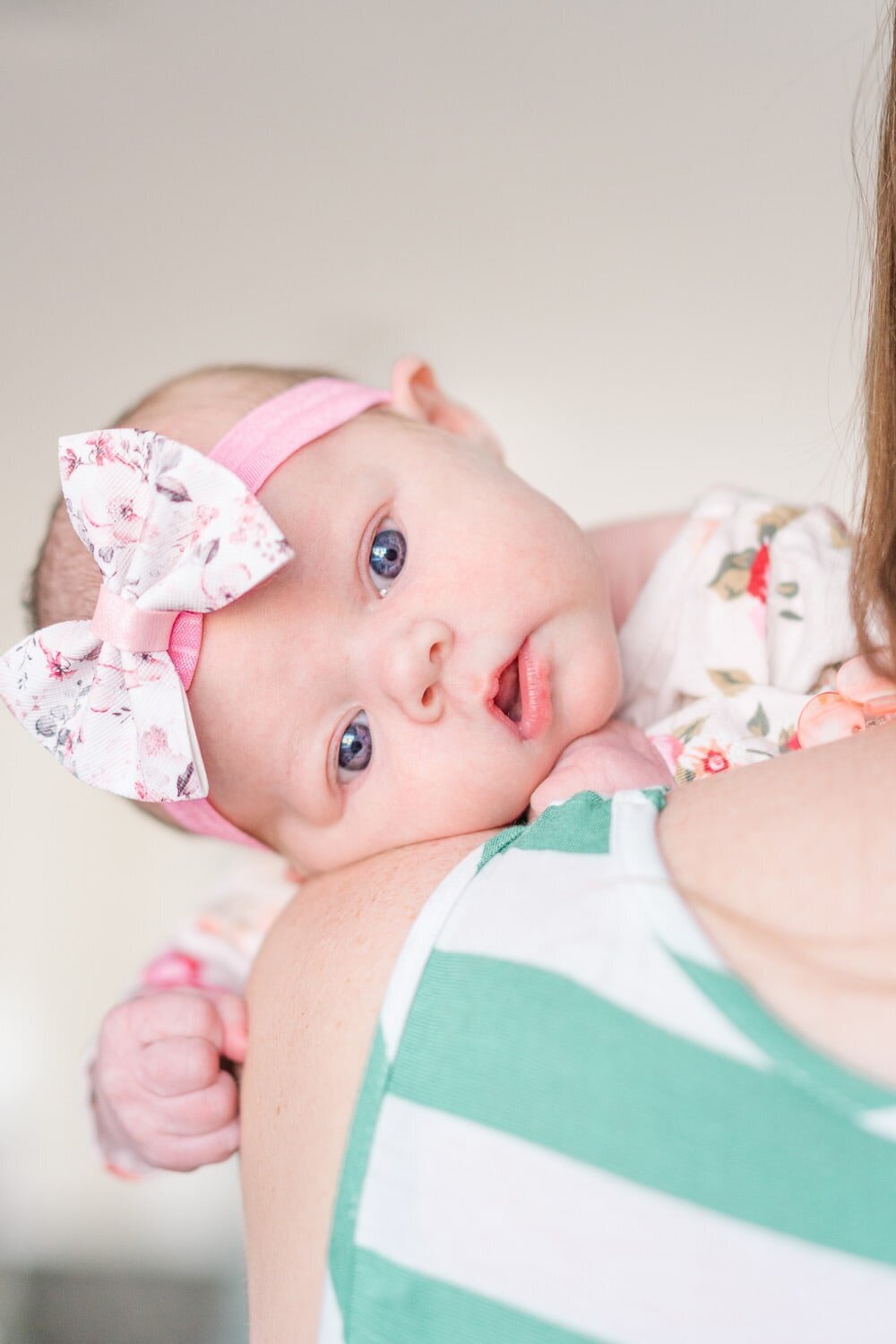 baby girl resting on mom's shoulder taken by a lifestyle newborn photographer in Alexandria, Virginia