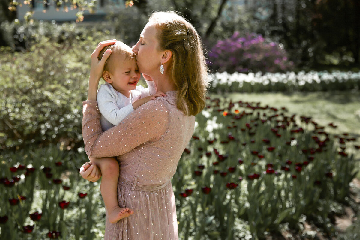 Mother embraces her child next to the tulips at Sherwood Gardens in Baltimore, Maryland during photo session