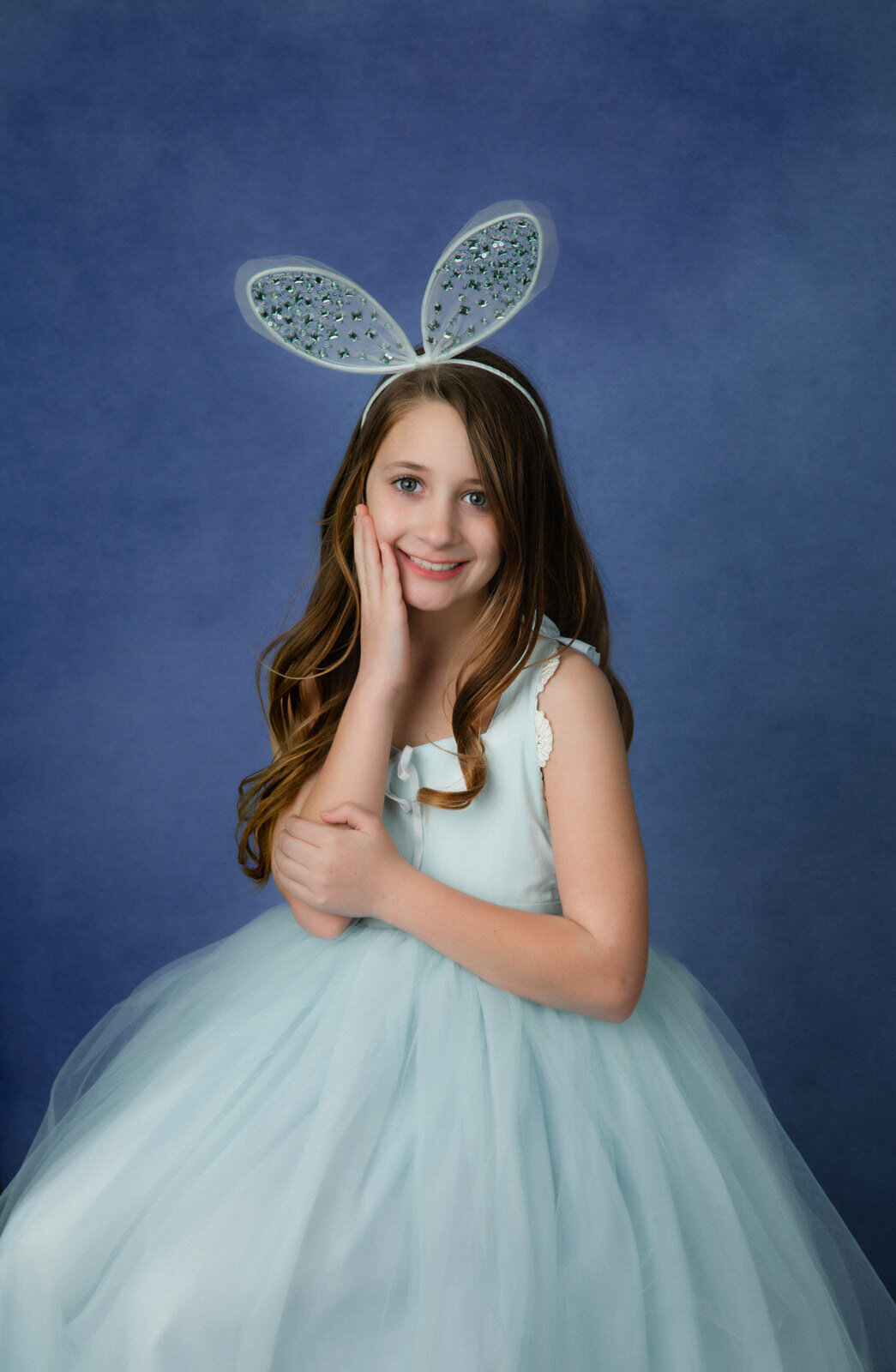 girl-wearing-bunny-ears-with-couture-gown-in-studio-for-easter-portraits