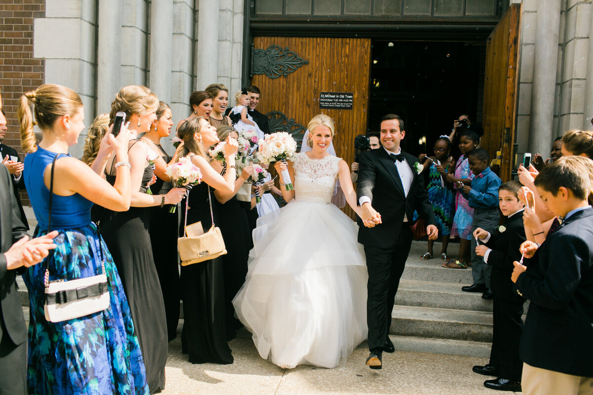 Newlyweds exit the church at the end of their wedding ceremony in Chicago