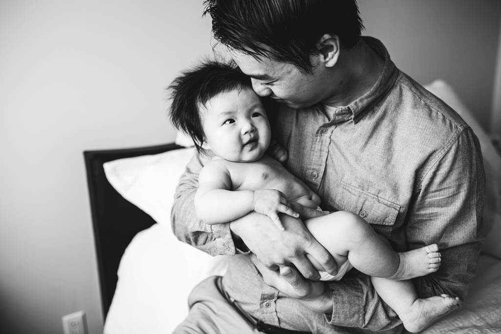 In home lifestyle portrait of San Francisco dad holding daughter