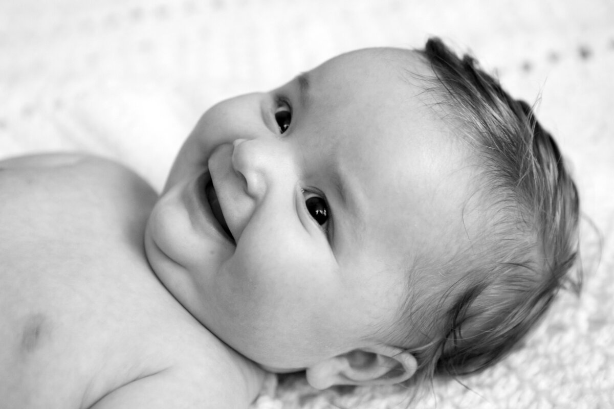 Black and white photo of a smiling baby Rockland baby photographer Milestone Images