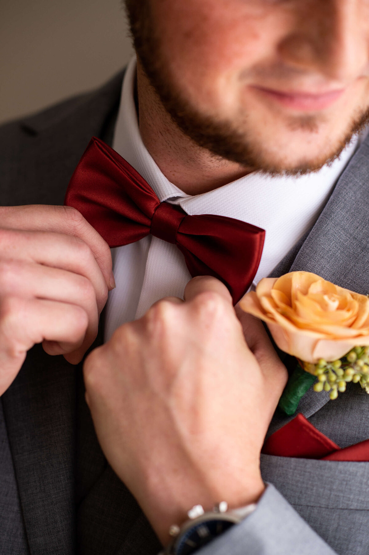 Ottawa wedding photography of a burgundy bow tie and yellow rose taken in the bridal suite at Strathmere wedding venue in Ottawa