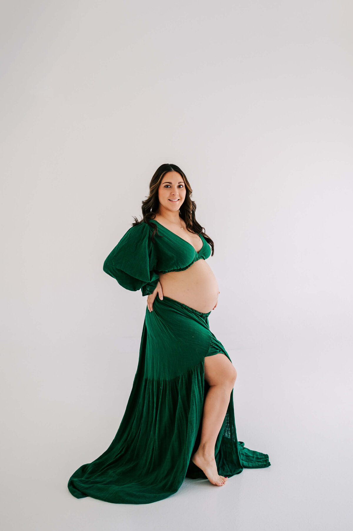 pregnant mom in green dress smiling