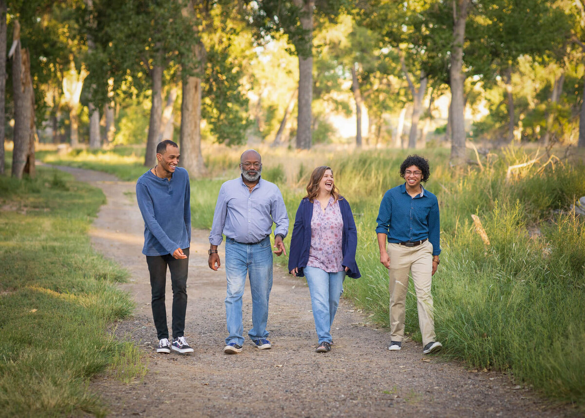 family of four walking together down a path