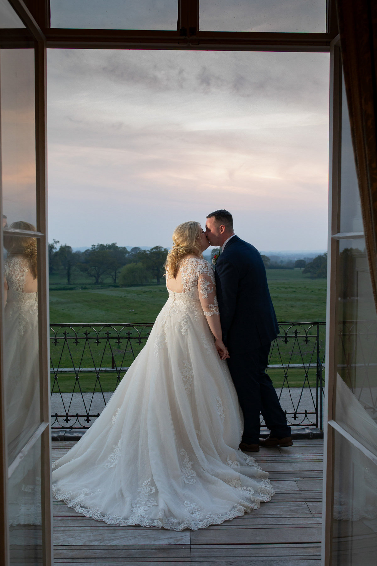 Bride and Groom at Sunset at Rockbeare Manor balcony_