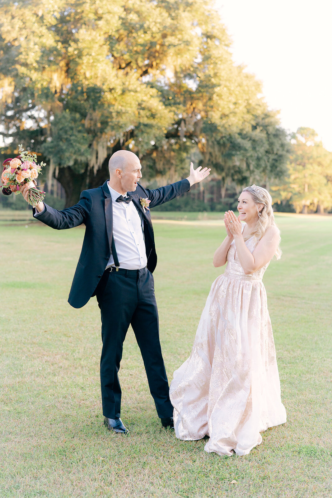 Intimate elopement in Charleston. Bride and groom celebrate during golden sunset at intimate elopement in Charleston.