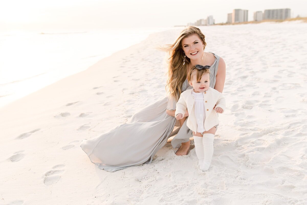 beautiful mom in a flowy dress with her baby during destin beach family photography