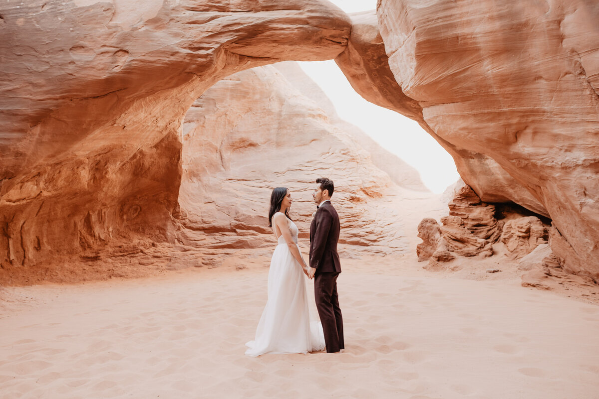 Utah elopement photographer captures couple holding hands in Arches National Park