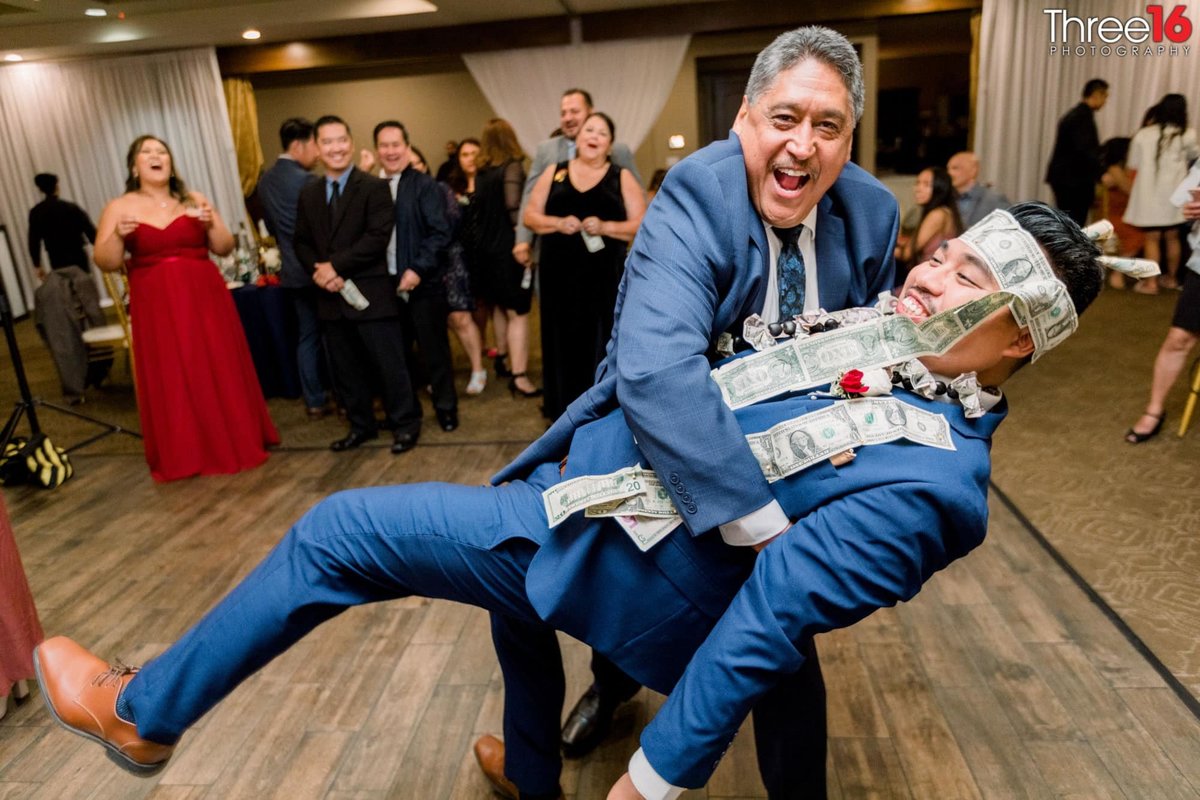 Man dips the Groom during the Money Dance