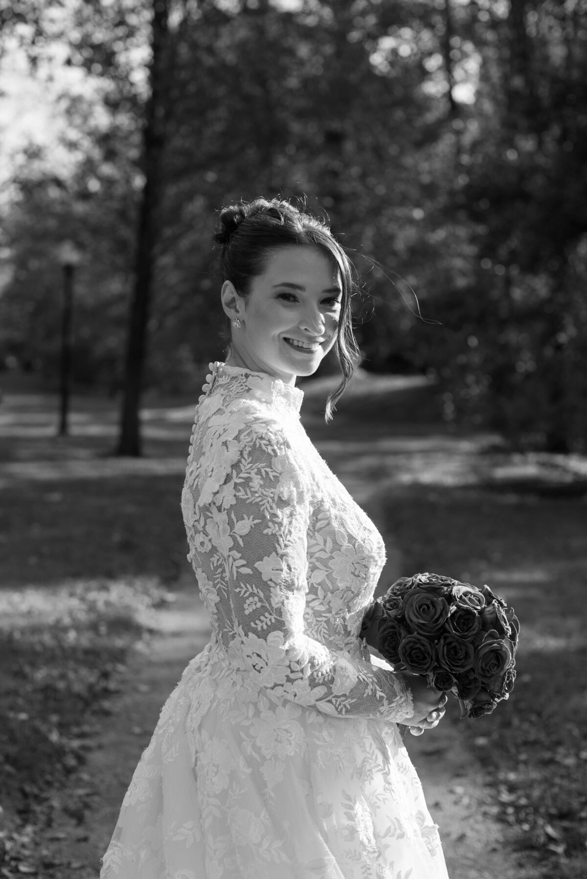 Bride wearing lace dress and carrying red bouquet by Halifax wedding photographer, Alyssa Joy Photography