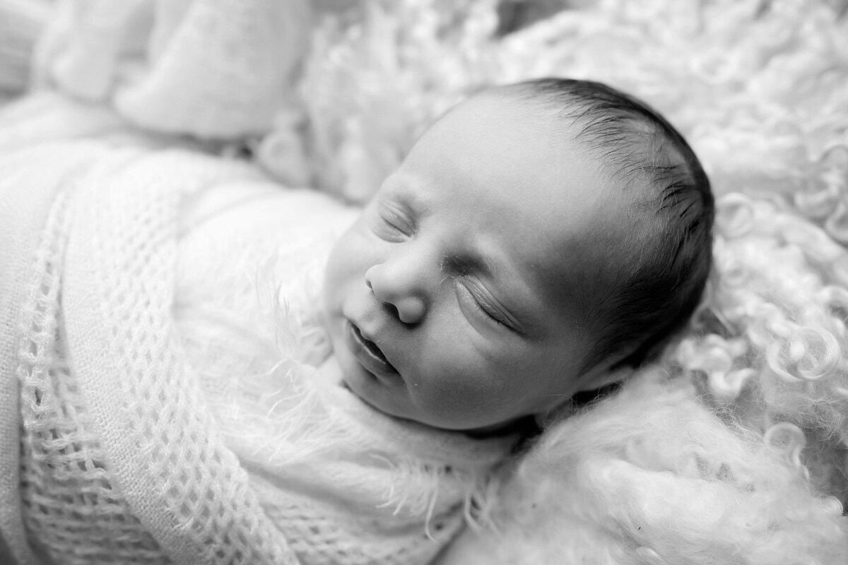 Newborn session of swaddled baby boy