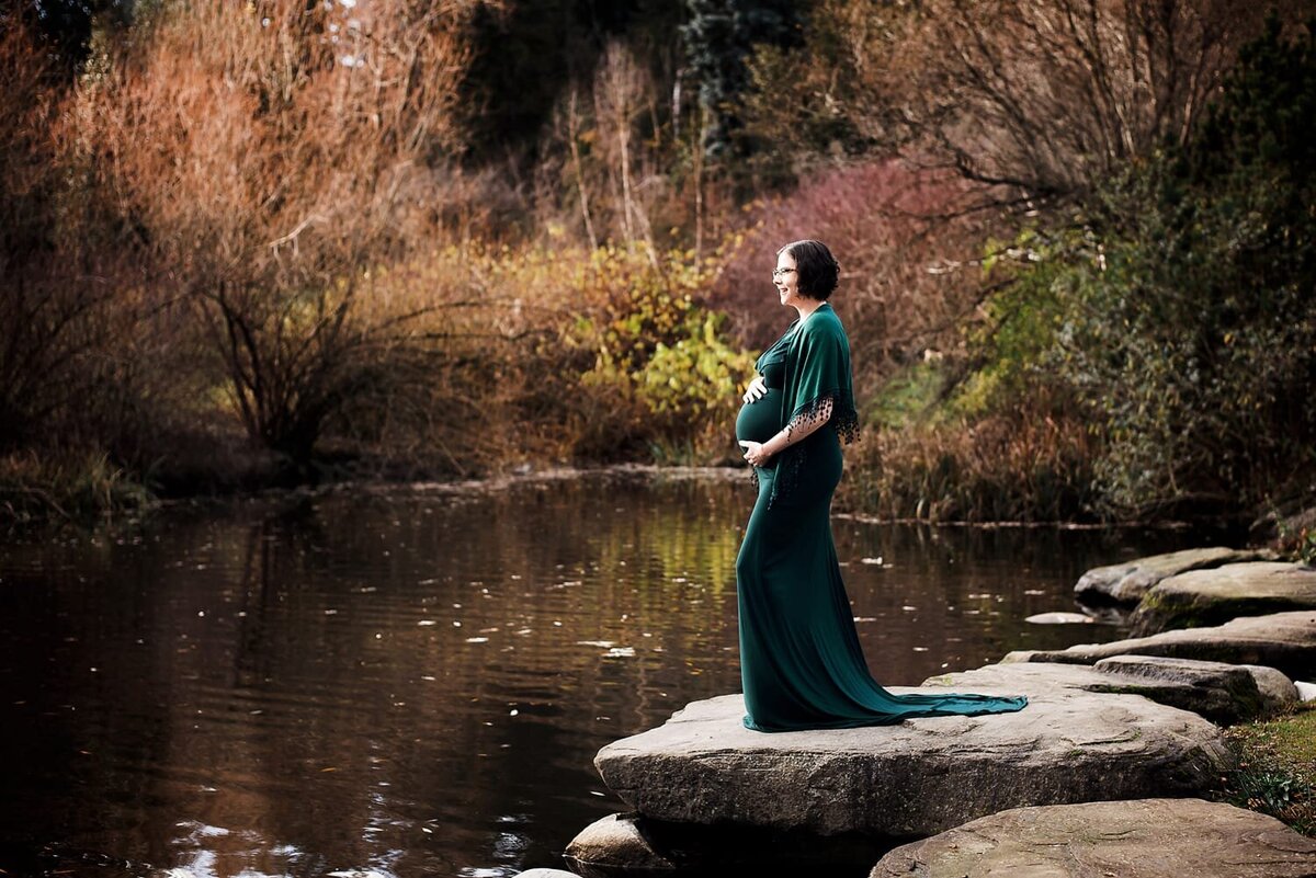 Queen Elizabeth Park maternity session overlooking lake with mom in green dress
