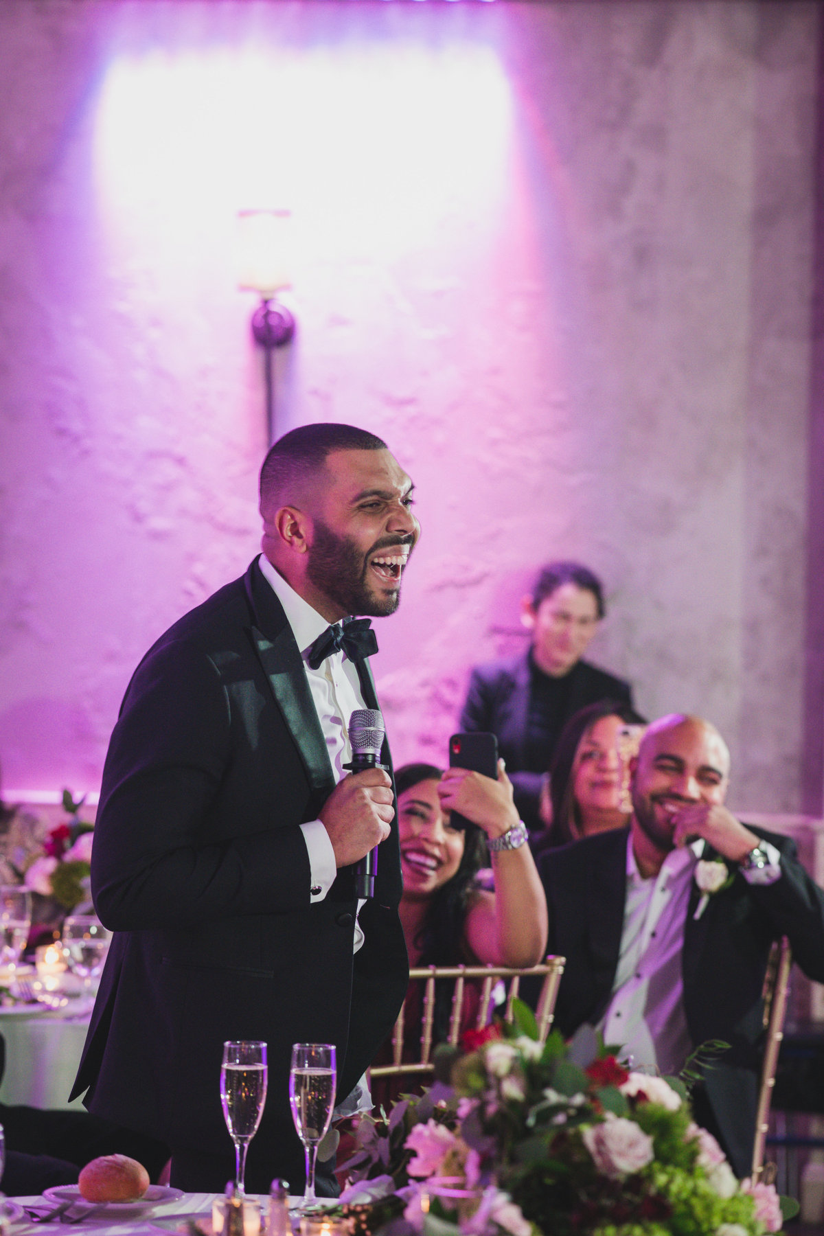 best man laughing while giving his speech at wedding reception at The Loft by Bridgeview