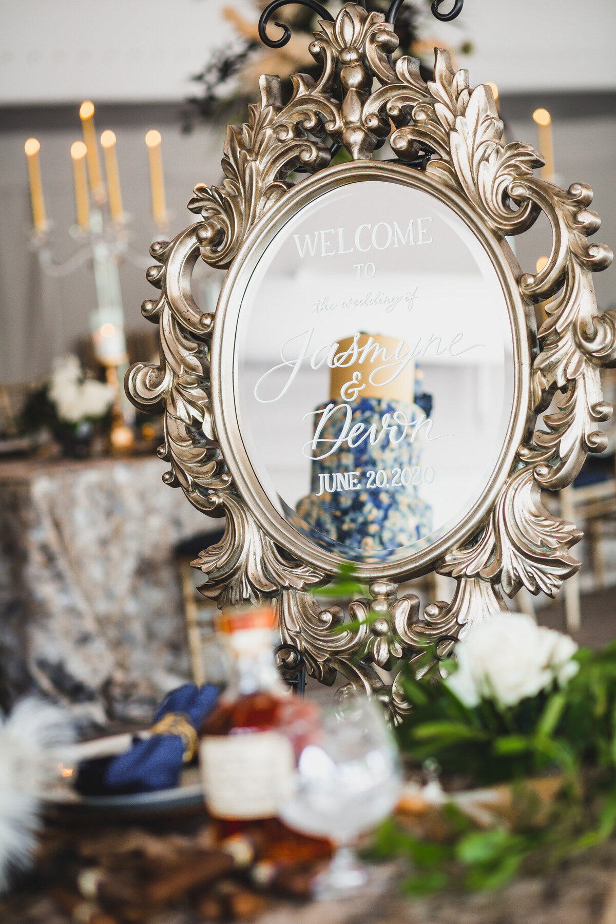 Wedding reception table and small round mirror with wedding details