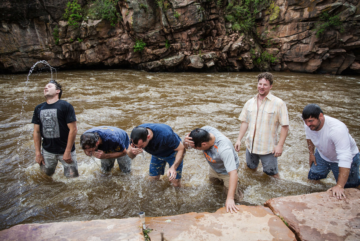 Fun photo of a groom and his best friends bathing in the Saint Vrain river at River Bend in Lyons Colorado