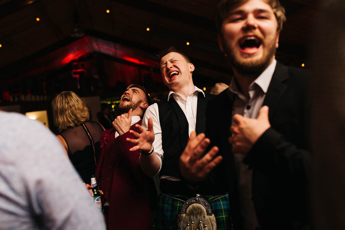 Guests candidly captured dancing at a wedding