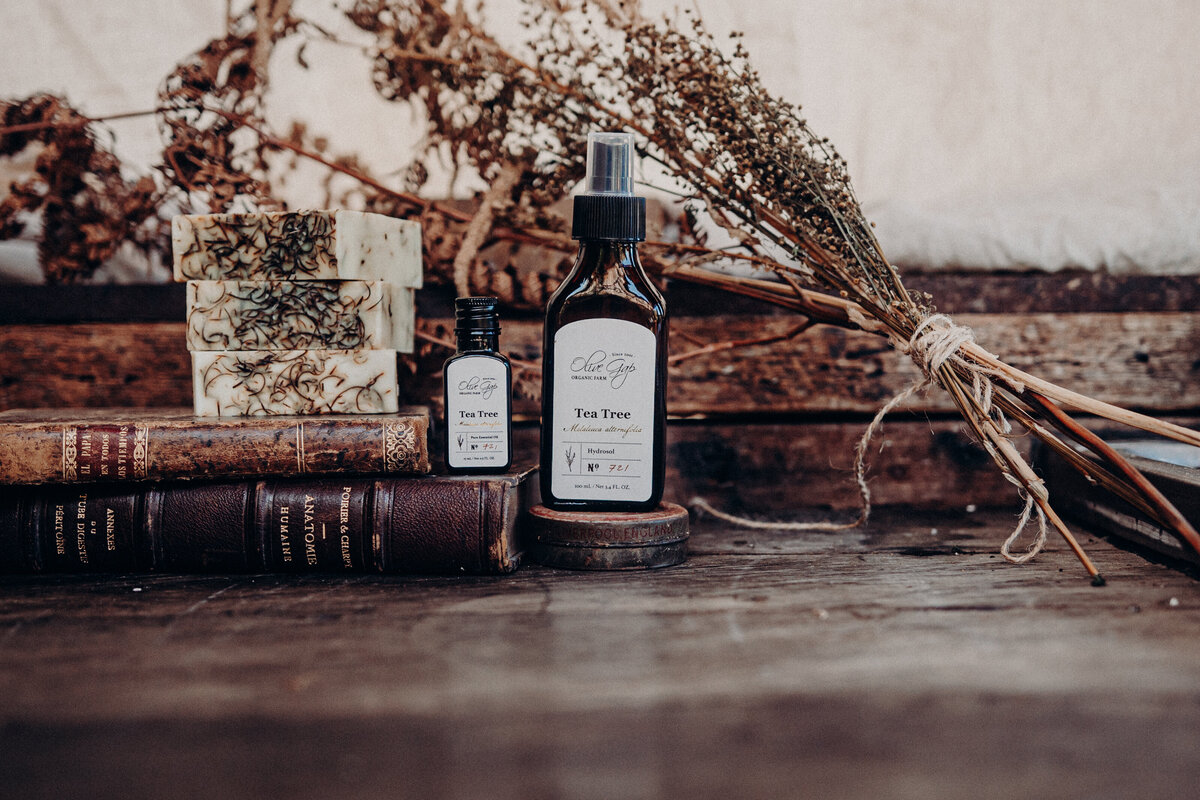 Product shot of Tea Tree Oil with natural backdrop behind