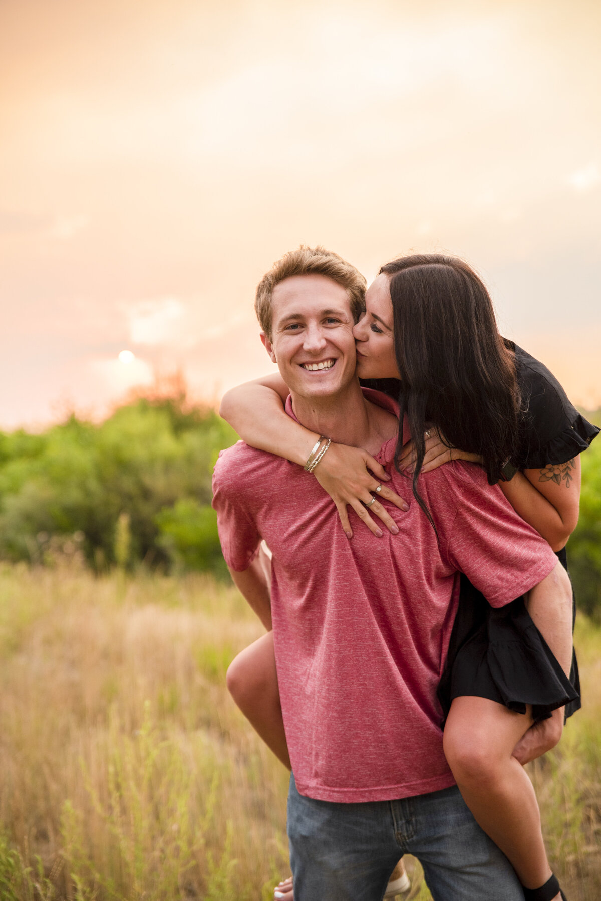Couples session in Longmont Colorado with little black dress and pink shirt during summer fire season