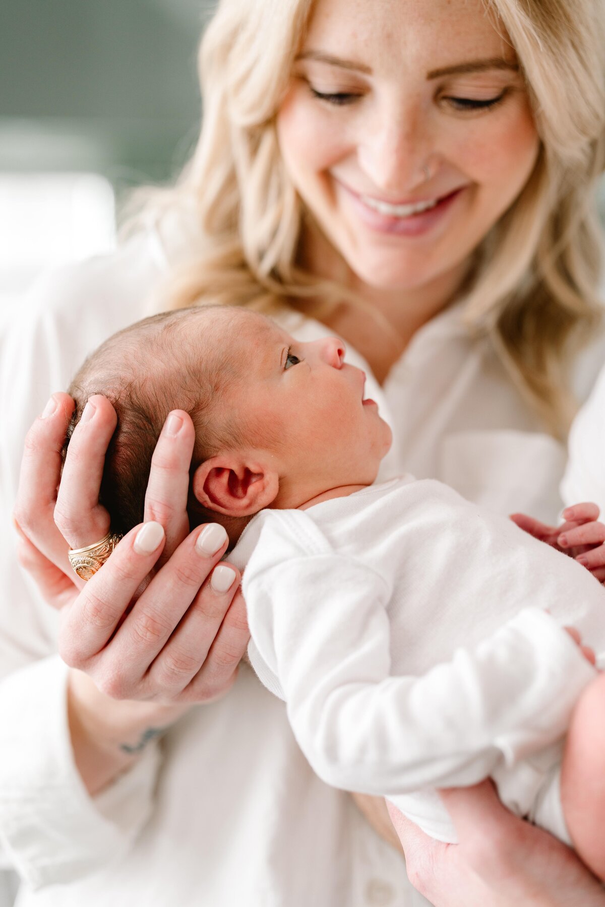Mother gazing at newborn