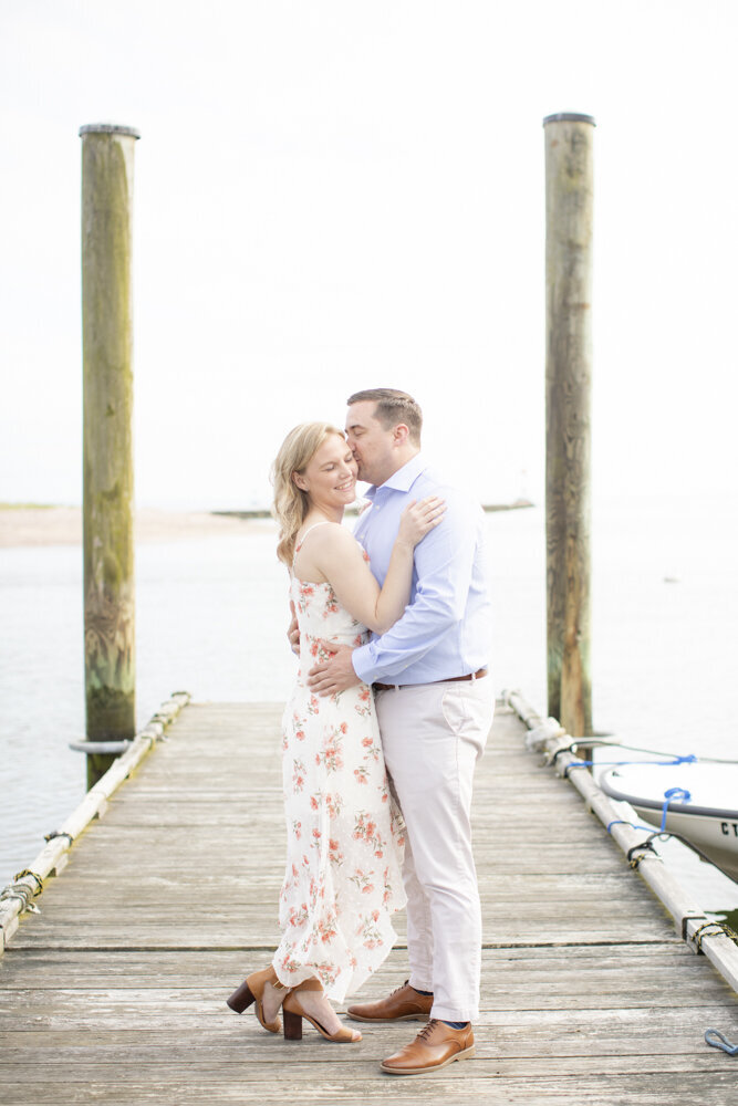 engagement photo of beautiful couple on wooden dock