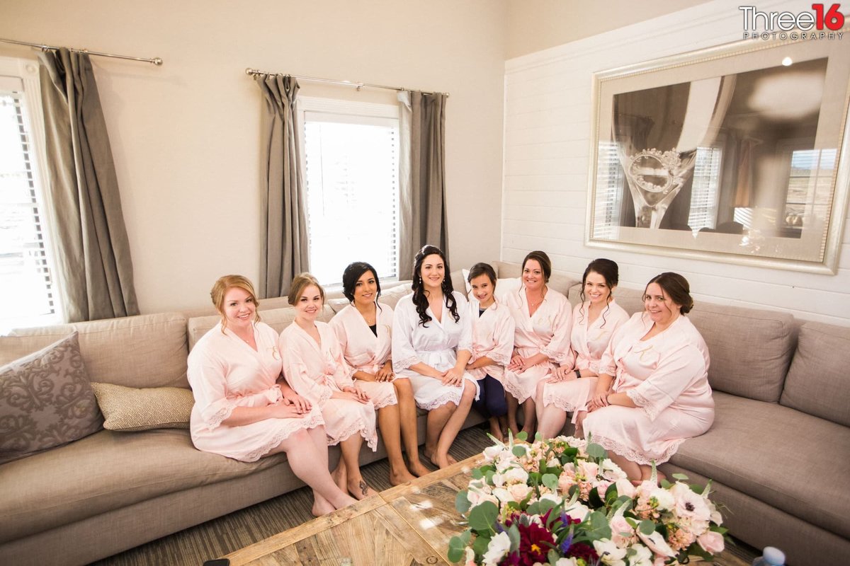 Bride and her Bridesmaids wearing their robes prior to getting ready for the ceremony