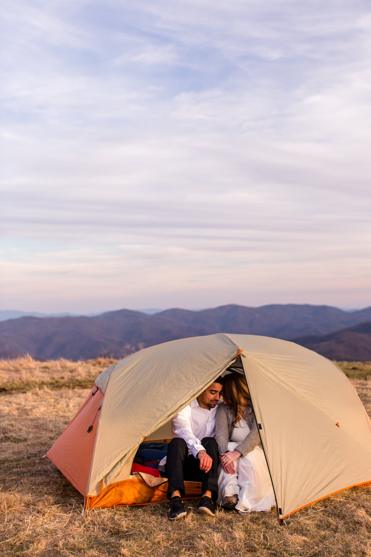 Bride and groom in a tent on top of a mountain